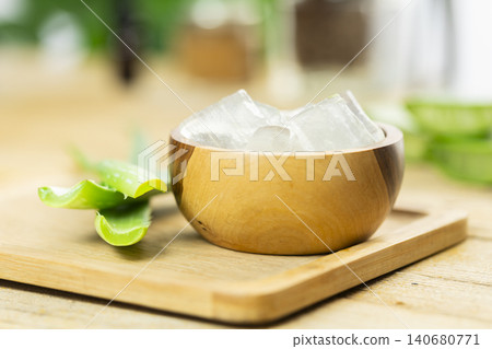 aloe vera and pieces of its pulp on a wooden pit aloe vera and pieces of its pulp on a wooden pit 140680771