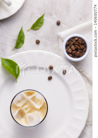 Refreshing iced coffee, with roasted coffee beans, on white background Refreshing iced coffee, with roasted coffee beans, on white background 140680774