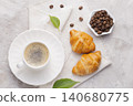 Coffee glass, roasted coffee beans and bread on the white table 140680775