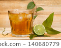 glass with lemon tea on wood 140680779