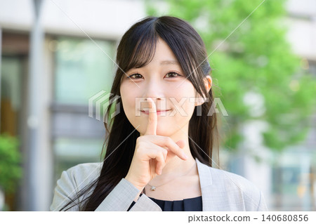 Japanese woman making a secret gesture 140680856