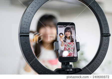 Japanese woman taking photos of sweets with her smartphone Japanese woman taking photos of sweets with her smartphone 140680872