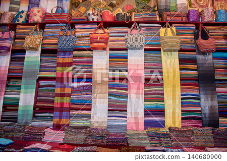 A local bazaar displays traditional leather crafts and textiles typical of Maghrebi culture in Fez, Morocco 140680900