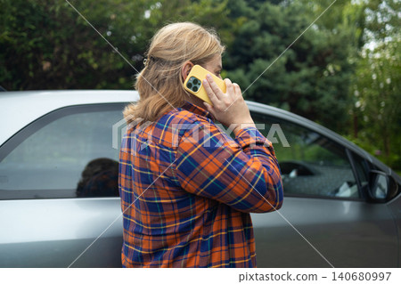 Young woman tourist talking on smartphone next to white car Young woman tourist talking on smartphone next to white car 140680997
