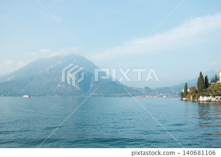 Sailboat on Lake Como against a mountain backdrop Sailboat on Lake Como against a mountain backdrop 140681106