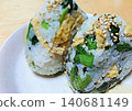 Rice ball with plenty of ingredients: komatsuna (Japanese mustard spinach) and fried tofu. Rice ball with plenty of ingredients: komatsuna (Japanese mustard spinach) and fried tofu. 140681149