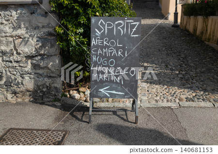 Chalkboard menu sign outside european cafe advertising summer cocktails Chalkboard menu sign outside european cafe advertising summer cocktails 140681153