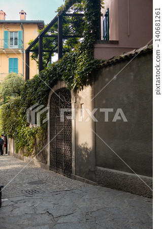 Narrow cobblestone street along a historic stone wall Narrow cobblestone street along a historic stone wall 140681261