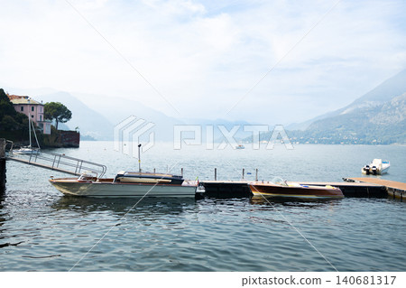 Sailboat on Lake Como against a mountain backdrop Sailboat on Lake Como against a mountain backdrop 140681317