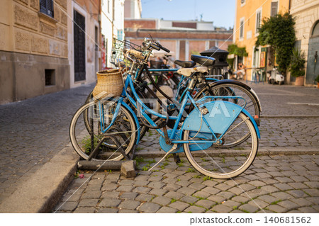 Vintage bicycles parked on cobblestone street in old European town Vintage bicycles parked on cobblestone street in old European town 140681562