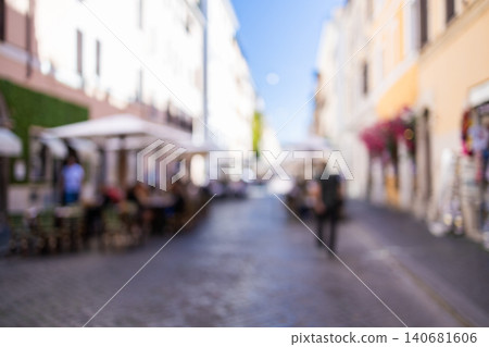 Sunny European street with people and outdoor cafe in bokeh defocus Sunny European street with people and outdoor cafe in bokeh defocus 140681606