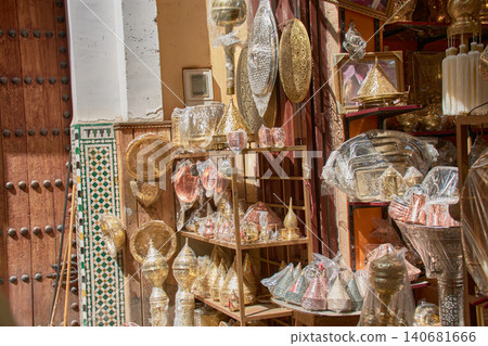Handcrafted metal lanterns hang at the entrances of shops in an alleyway in Fez, Morocco. Handcrafted metal lanterns hang at the entrances of shops in an alleyway in Fez, Morocco. 140681666