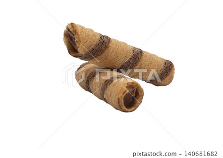 Close up photo of cylindrical wafer rolls filled with chocolate cream 140681682