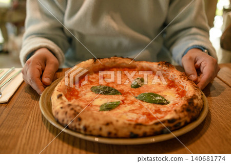 Serving fresh margherita pizza on wooden table Serving fresh margherita pizza on wooden table 140681774