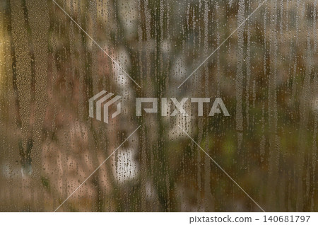 Moisture beads run down fogged glass. Moisture beads run down fogged glass. 140681797