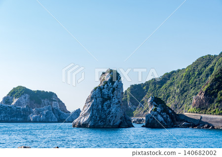 The rugged, strangely shaped rocks rising from the blue sea and the scenery of the coastline. The rugged, strangely shaped rocks rising from the blue sea and the scenery of the coastline. 140682002