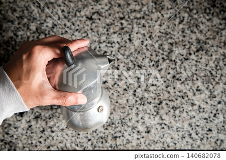 A silver tea pot sits on a countertop A silver tea pot sits on a countertop 140682078