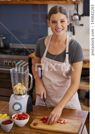 Woman, portrait and fruit smoothie in kitchen for weight loss nutrition, healthy or vitamins. Female person, face and knife with cutting board for juicer shake or blender, ingredients or preparation Woman, portrait and fruit smoothie in kitchen for weight loss nutrition, healthy or vitamins. Female person, face and knife with cutting board for juicer shake or blender, ingredients or preparation 140682263