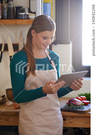Woman, cooking and online tablet with vegetables for healthy diet recipe, nutrition or kitchen. Female person, chef and apron with technology for vegetarian meal or ingredients, lunch or browsing Woman, cooking and online tablet with vegetables for healthy diet recipe, nutrition or kitchen. Female person, chef and apron with technology for vegetarian meal or ingredients, lunch or browsing 140682266