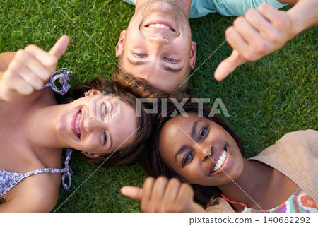 Students, group and thumbs up on grass for diversity, portrait and above for education at university. Friends, man and women with sign, vote or emoji for agreement, yes and smile with solidarity Students, group and thumbs up on grass for diversity, portrait and above for education at university. Friends, man and women with sign, vote or emoji for agreement, yes and smile with solidarity 140682292