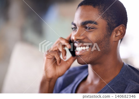 African man, phone call and home on sofa with smile for conversation, contact and listening in lounge. Person, smartphone and happy for mobile connection, talking and chat on couch in house. African man, phone call and home on sofa with smile for conversation, contact and listening in lounge. Person, smartphone and happy for mobile connection, talking and chat on couch in house. 140682346
