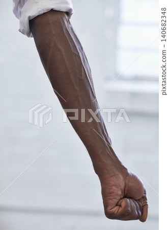 Strong, person and vein from muscle in arm with fist for power in white background or fashion. African, hand and forearm of model with healthy fitness, wellness or muscular bodybuilder in office Strong, person and vein from muscle in arm with fist for power in white background or fashion. African, hand and forearm of model with healthy fitness, wellness or muscular bodybuilder in office 140682348
