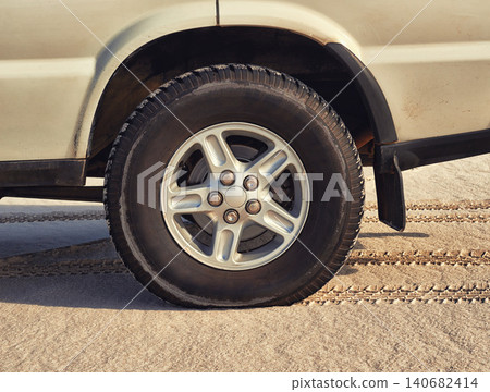 Tyre, car in desert and travel with transport outdoor, off road vehicle for sand dunes and journey on vacation. Wheel, 4x4 and SUV with adventure, exploration and destination for tourism in Dubai Tyre, car in desert and travel with transport outdoor, off road vehicle for sand dunes and journey on vacation. Wheel, 4x4 and SUV with adventure, exploration and destination for tourism in Dubai 140682414