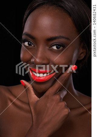 Black woman, lipstick and nail polish for beauty with smile, cosmetics and bright makeup on dark background. Bold, vibrant and orange lip balm with manicure, cosmetology and glamour in studio Black woman, lipstick and nail polish for beauty with smile, cosmetics and bright makeup on dark background. Bold, vibrant and orange lip balm with manicure, cosmetology and glamour in studio 140682431