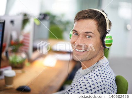Portrait, office and headphone for happy male worker, computer and podcast for entertainment. Technology, employee and radio streaming at workspace in Holland, startup or entrepreneur for company Portrait, office and headphone for happy male worker, computer and podcast for entertainment. Technology, employee and radio streaming at workspace in Holland, startup or entrepreneur for company 140682456