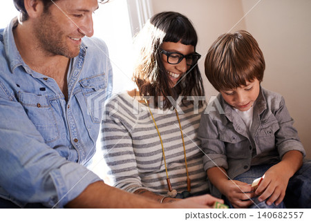 Parents, boy and together in family home, smile and happy laughing while playing with toy. Kid, development for growth or learning and love on vacation, holiday or bond and caring mother or father Parents, boy and together in family home, smile and happy laughing while playing with toy. Kid, development for growth or learning and love on vacation, holiday or bond and caring mother or father 140682557