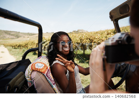Women, peace sign or camera on road trip in countryside, photography or travel adventure as friends in nature. Ladies, driving or safari in suv on summer holiday or bonding together for trip in texas Women, peace sign or camera on road trip in countryside, photography or travel adventure as friends in nature. Ladies, driving or safari in suv on summer holiday or bonding together for trip in texas 140682568