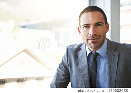 Business man, portrait and corporate professional in an office ready for work at a company window. Serious, suit and investment manager with confidence at an accounting firm with a male executive 140682688