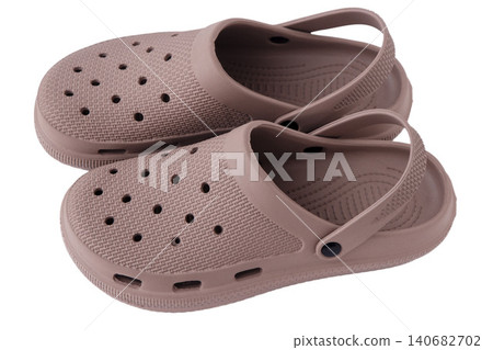 Pair of dusty rose rubber clogs isolated on white background Pair of dusty rose rubber clogs isolated on white background 140682702