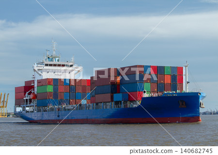 Container ship cargo vessel freight logistics shipping ocean transport carrying colorful container on open water near port, global trade concept under blue sky, calm seascape 140682745