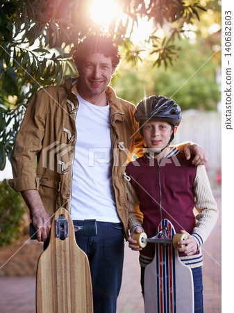 Father, son and skateboard outdoor in portrait for sports and fun, bonding for love and relationship. Happy people, skating and activity in neighborhood for family time, helmet for safety and hobby Father, son and skateboard outdoor in portrait for sports and fun, bonding for love and relationship. Happy people, skating and activity in neighborhood for family time, helmet for safety and hobby 140682803