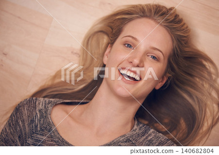 Happy, portrait and woman on a floor with confidence, positive attitude or feel good mood from above. Face, smile and female person relax in a living room on day off, weekend or vacation in her home Happy, portrait and woman on a floor with confidence, positive attitude or feel good mood from above. Face, smile and female person relax in a living room on day off, weekend or vacation in her home 140682804
