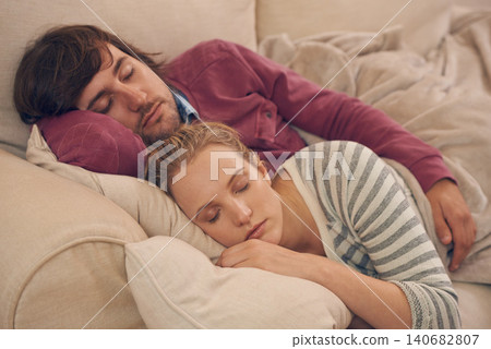 Sleeping, peace and couple relax on a sofa with care, support and safety, security and bonding in their home. Love, calm and tired people embrace in living room in comfort, nap or resting in a house Sleeping, peace and couple relax on a sofa with care, support and safety, security and bonding in their home. Love, calm and tired people embrace in living room in comfort, nap or resting in a house 140682807