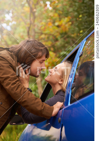 Travel, window and couple kiss in car for greeting, goodbye and love on journey, leaving and commute. Transport, driving and man and woman in vehicle for bonding, relationship or embrace on road trip Travel, window and couple kiss in car for greeting, goodbye and love on journey, leaving and commute. Transport, driving and man and woman in vehicle for bonding, relationship or embrace on road trip 140682809