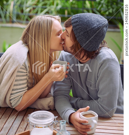 Kiss, garden and couple with coffee in morning with drink, caffeine beverage and cappuccino outdoors. Happy, love and man and woman with mug in backyard for breakfast, bonding and wellness together Kiss, garden and couple with coffee in morning with drink, caffeine beverage and cappuccino outdoors. Happy, love and man and woman with mug in backyard for breakfast, bonding and wellness together 140682816