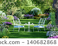 Romantic garden seating area with elegant white metal chairs and tea table 3d render 140682868