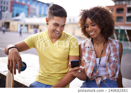 Happy, phone and couple with skateboard in city for exercise, training and sports hobby in town. Skate park, fashion and man and woman on smartphone for social media, networking and online chat Happy, phone and couple with skateboard in city for exercise, training and sports hobby in town. Skate park, fashion and man and woman on smartphone for social media, networking and online chat 140682881