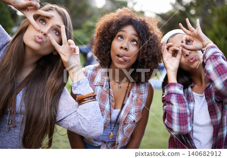 Funny, face and friends in a park with silly, fun or bonding on vacation, weekend or reunion in nature. Crazy, expression and gen z women in a forest with goofy, comic or personality, joke or gesture 140682912