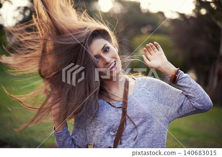 Woman, freedom and smile outside with hair flip, female person in nature or creative dancing or moving motion. Summer, enjoy or student on holiday with excited, head and cheerful or vacation dancer 140683015