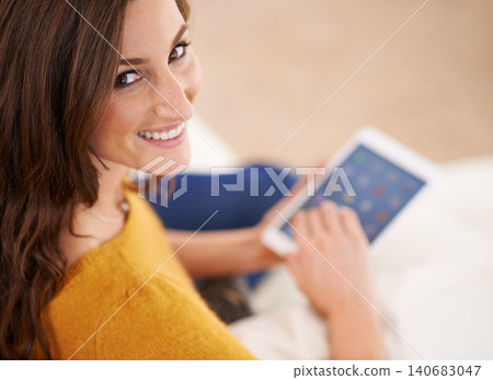 Happy, portrait and woman with tablet on sofa reading ebook on app to relax on holiday or vacation in home. Girl, smile and lounge on tech with blog, article or news from search on internet in house 140683047