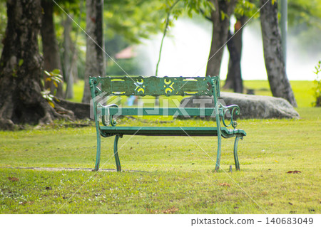 Park bench green bench empty bench garden park tree grass outdoor landscape peaceful daytime Park bench green bench empty bench garden park tree grass outdoor landscape peaceful daytime 140683049