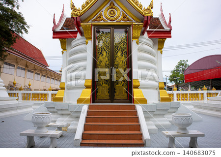 Ornate temple entrance with golden door, white shrine exterior, red roof, and stone steps in quiet asian courtyard Ornate temple entrance with golden door, white shrine exterior, red roof, and stone steps in quiet asian courtyard 140683075