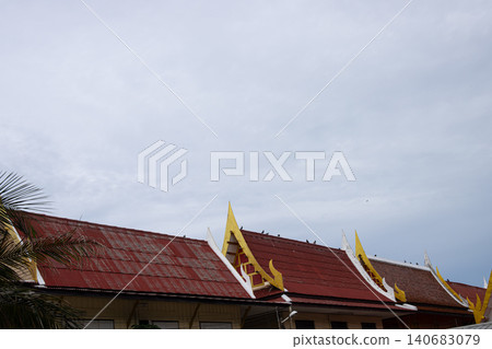 Red roof temple building with golden gable and cloudy sky Red roof temple building with golden gable and cloudy sky 140683079
