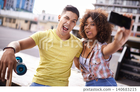 Selfie, emoji and couple with skateboard in city for exercise, training and sports hobby in town. Skate park, fashion and man and woman on smartphone for social media, networking and online post 140683215