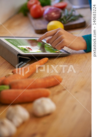 Hand, cooking and tablet with vegetables in kitchen as nutrition meal or online recipe, diet or connectivity. Person, home and raw ingredients with internet or vegan eating or prepare, dinner or chef Hand, cooking and tablet with vegetables in kitchen as nutrition meal or online recipe, diet or connectivity. Person, home and raw ingredients with internet or vegan eating or prepare, dinner or chef 140683224
