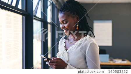 Phone, networking and professional black woman in the office browsing on social media or the internet. Smile, technology and African female person scroll on mobile app with cellphone in workplace. 140683232